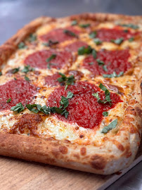 A pizza with pepperoni and cheese on top.